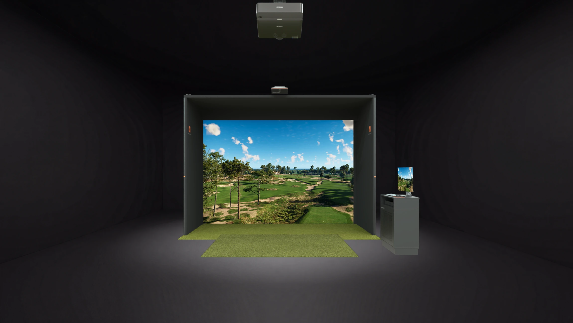 Indoor golf simulator room with a realistic green field projection and a computer station on the right.