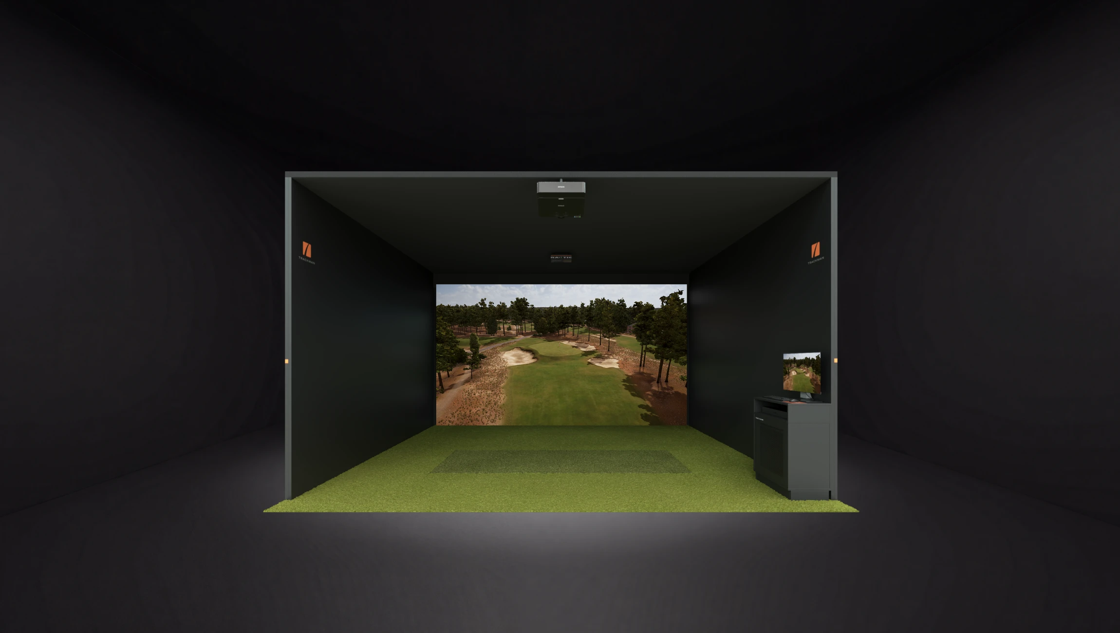 Indoor golf simulator setup with a large screen displaying a golf course, featuring green turf and a control panel on the side.
