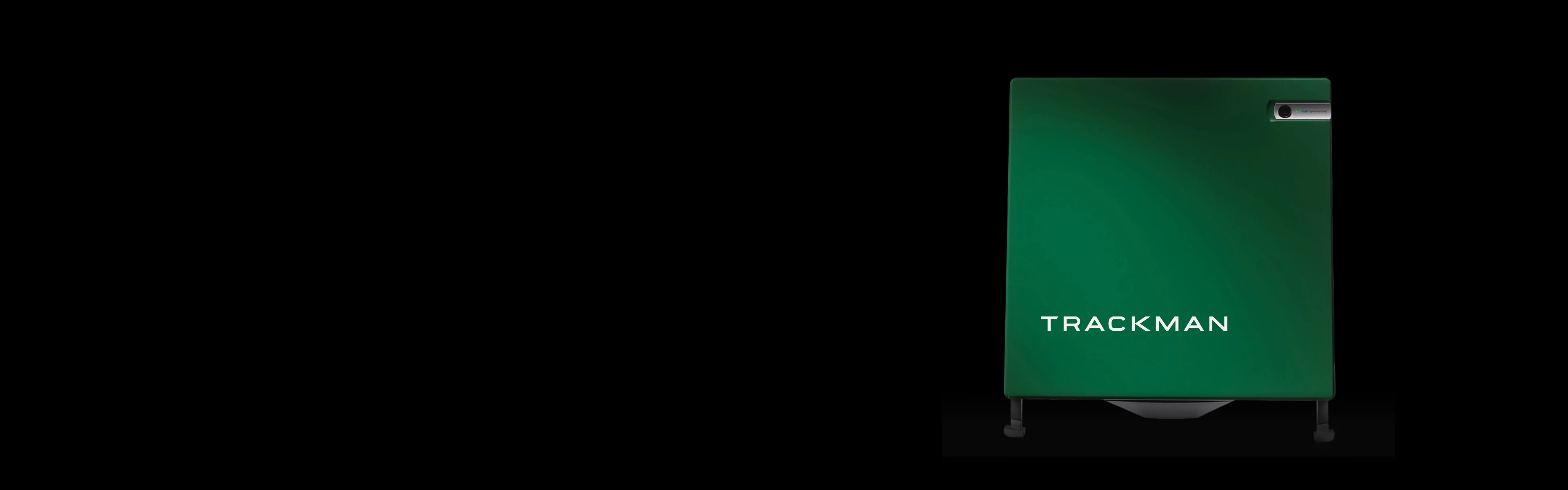 A green Trackman golf launch monitor against a black background, featuring the brand name in white text.