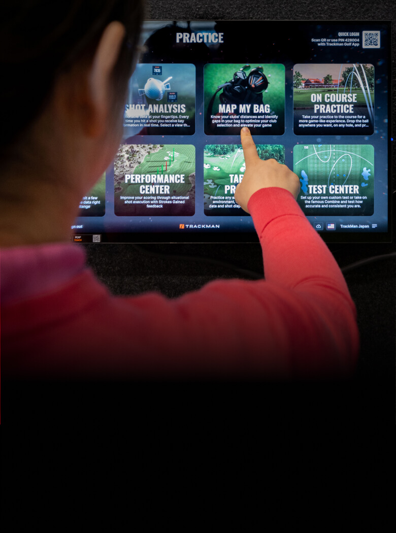 woman pointing at trackman screen showing TPS 10.1