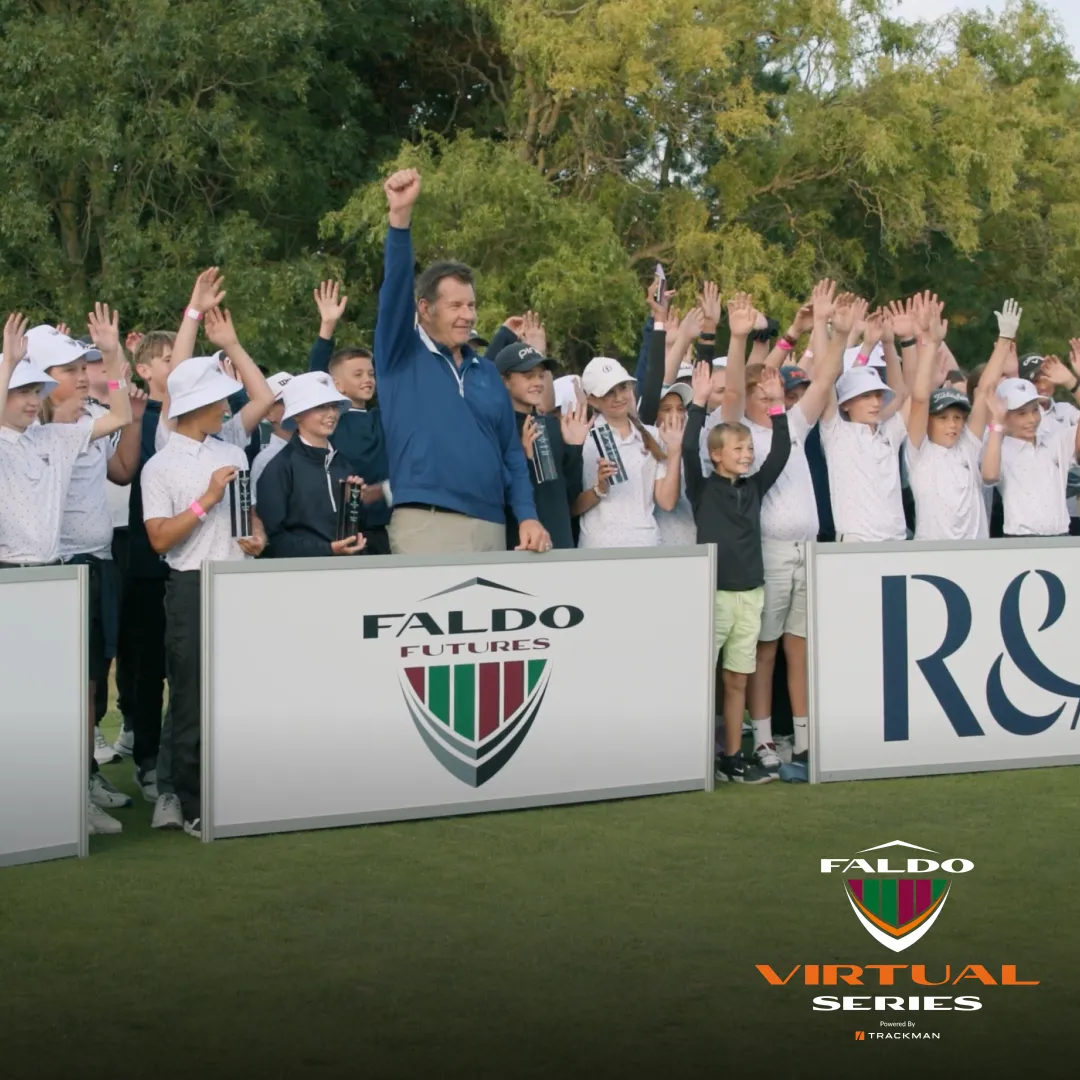 A group of young golfers and an adult celebrate behind banners reading "Faldo Futures" and "R&A," raising their hands on a golf course.