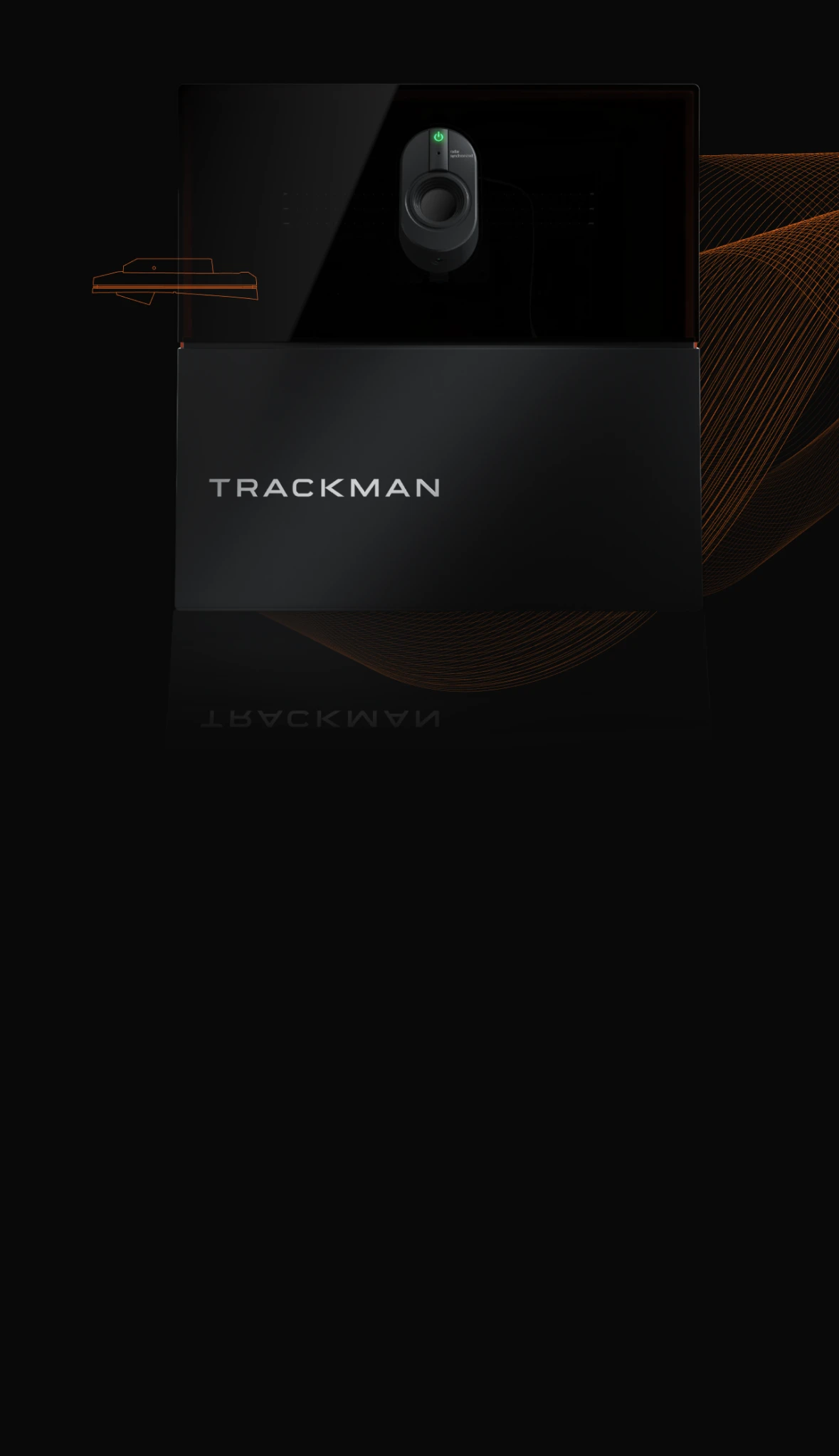 Close-up of a black TrackMan device on a dark background with subtle orange lines, featuring a prominent green power button.